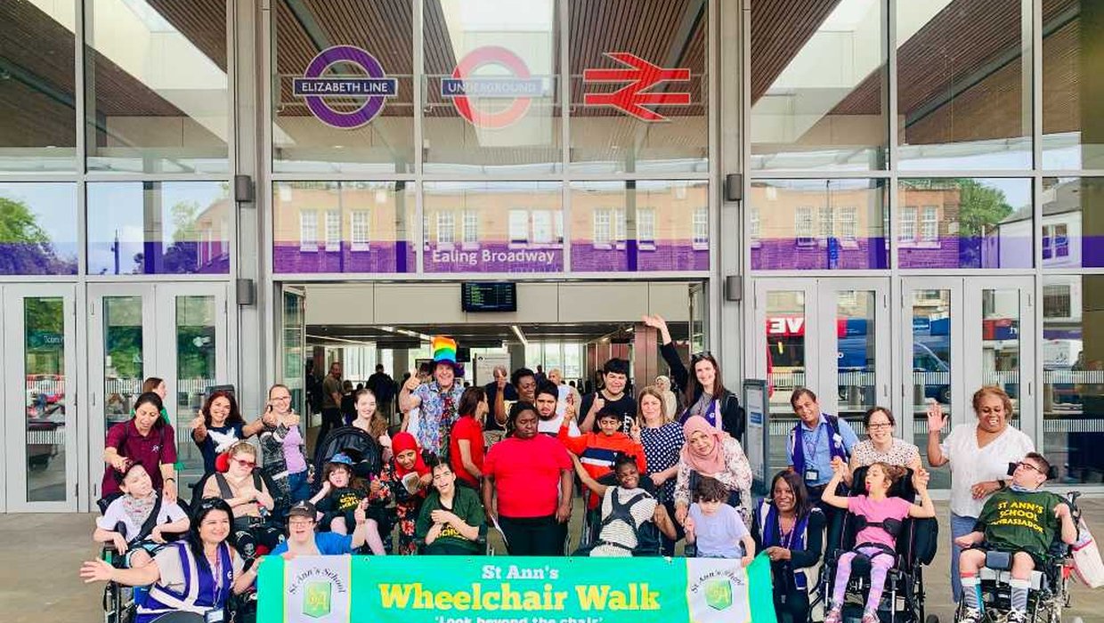 A group of children posing for a photo outside a tube station
